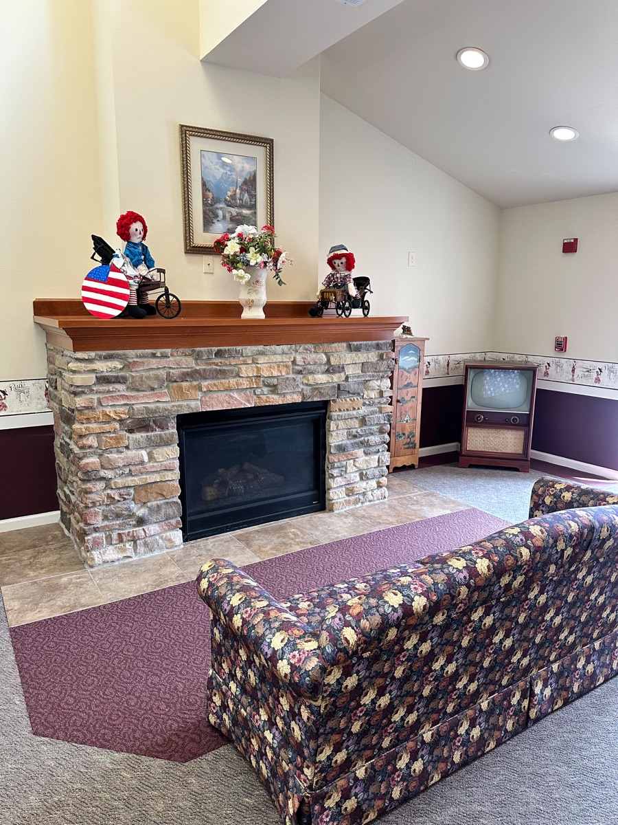 Common area with stone fireplace at Prairie Gardens
